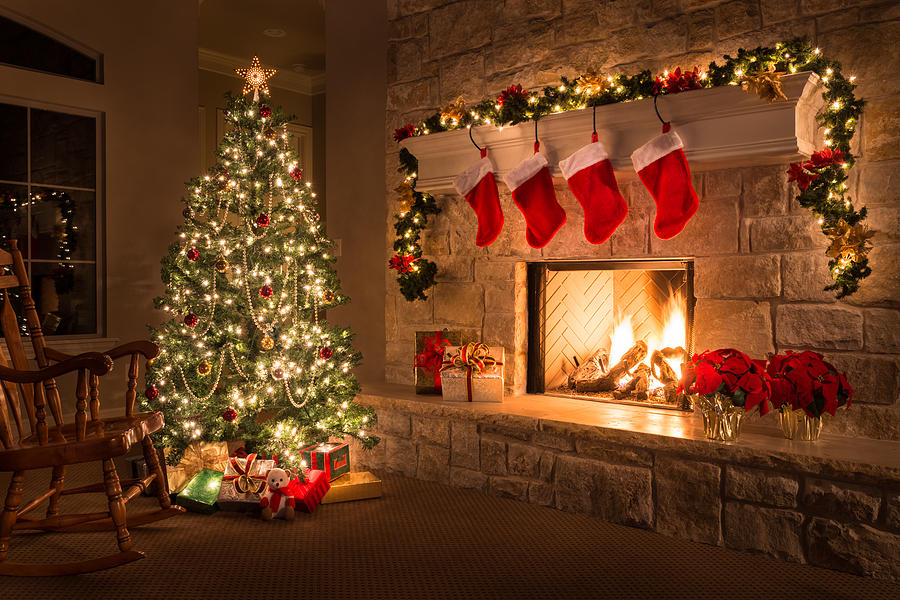 Christmas. Glowing fireplace, hearth, tree. Red stockings. Gifts and decorations. Photograph by Dszc
