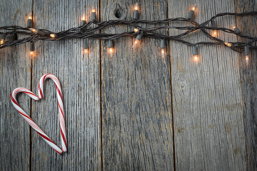 Candy Photograph - Christmas Lights and Heart Shaped Candy Canes on Rustic Wood Bac by Brandon Bourdages