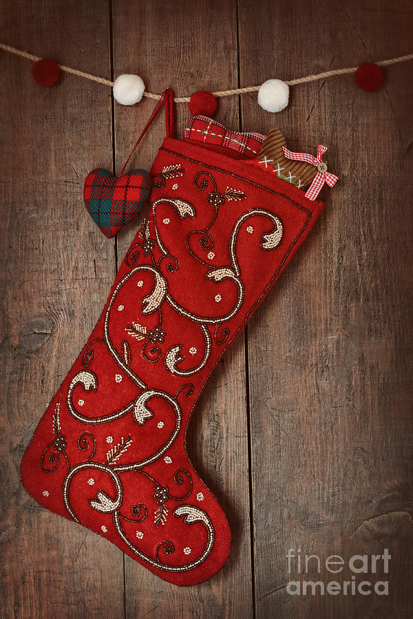 Christmas ornaments in stocking hanging on wood  Photograph by Sandra Cunningham