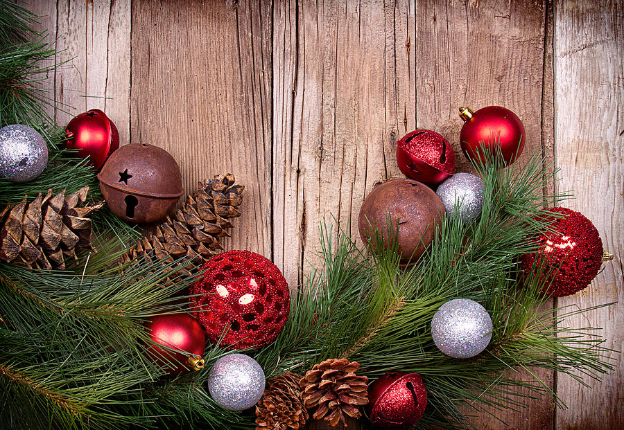 Christmas Photograph - Christmas ornaments on wooden background by Jennifer Huls