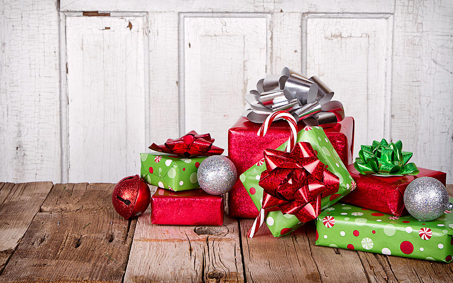 Christmas Photograph - Christmas Presents on Wooden Background by Jennifer Huls