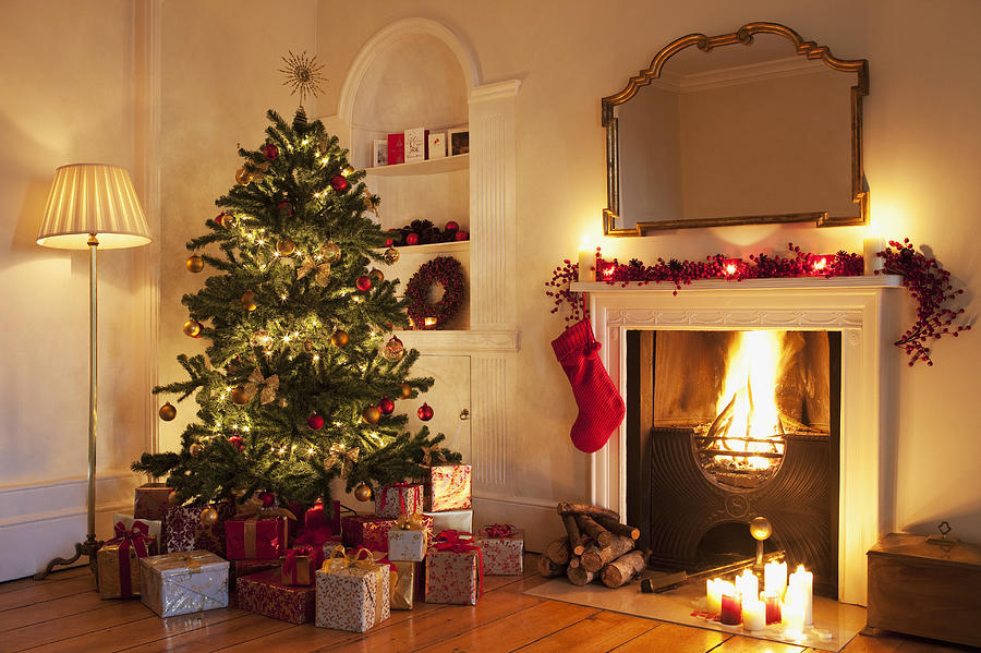 Christmas tree with gifts near fireplace Photograph by Tom Merton