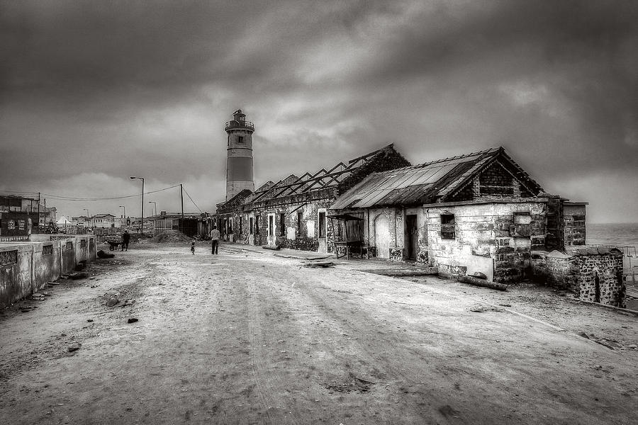 Cityscape with lighthouse Photograph by Roberto Pagani