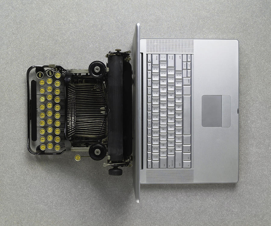 Classic analog typewriter vs Modern digital hi-tech laptop computer Photograph by FreezeFrameStudio