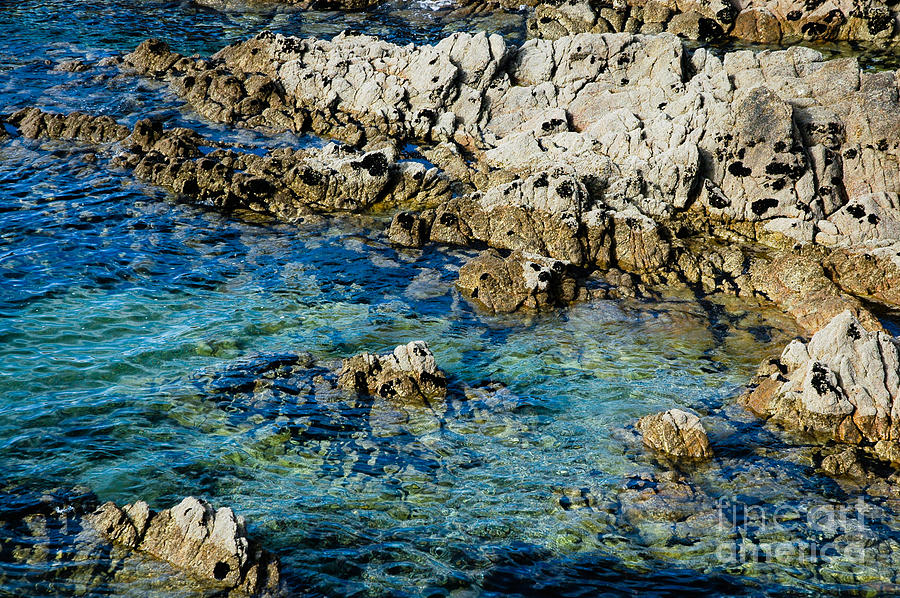 Clear blue green water between the rocks Cote Sauvage Quibron Britanny Photograph by Peter Noyce