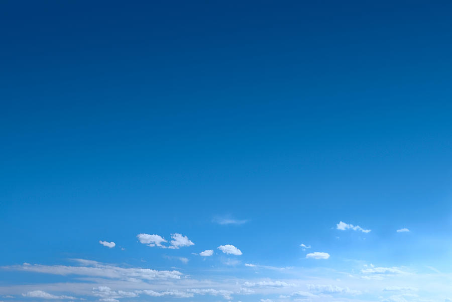 Clear Blue Sky Background With Scattered Clouds Photograph by Ryasick