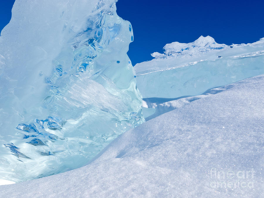 Abstract Photograph - Clear glacier ice chunks with snow and blue sky by Stephan Pietzko