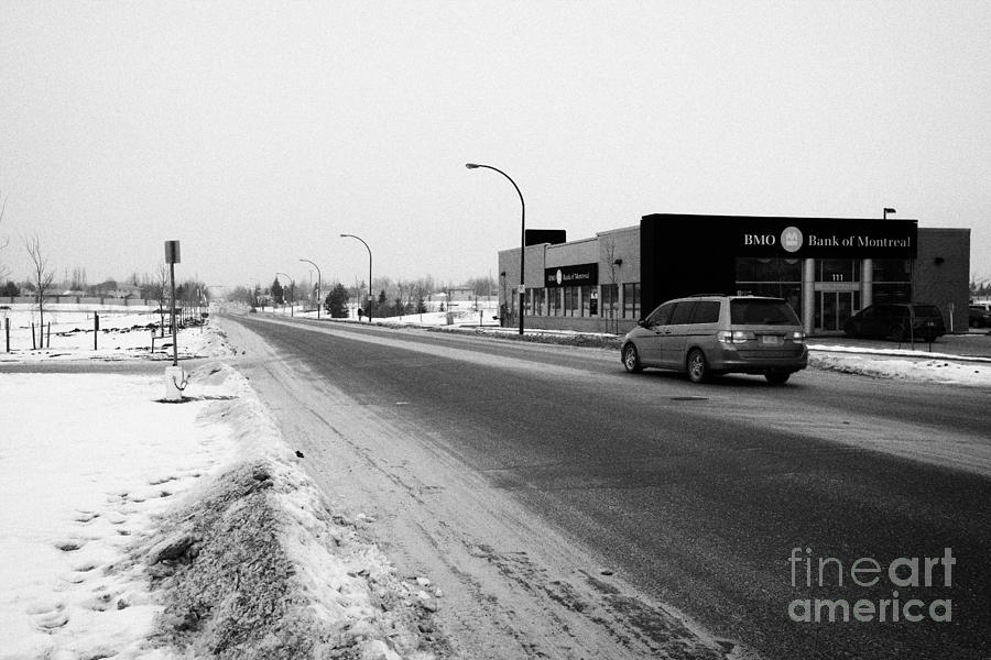 Winter Photograph - cleared salted gritted road in commercial district of Saskatoon Saskatchewan Canada by Joe Fox