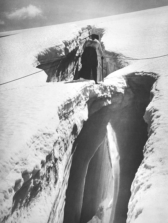 Black And White Photograph - Climber Crossing An Ice Bridge by Underwood Archives