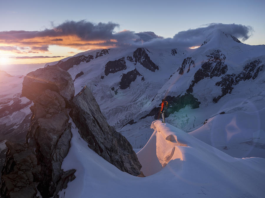 Climber on a peak watching sunrise Photograph by Buena Vista Images