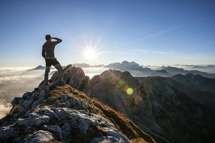 Climber standing on a mountain peak Photograph by Marcutti