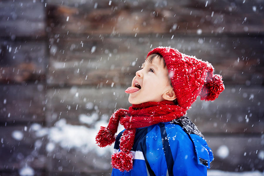 Close portrait of little boy, catching snowflakes Photograph by Tatyana Tomsickova Photography