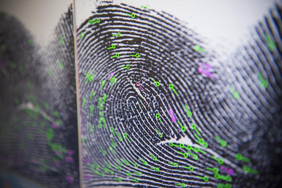 Close up detail of fingerprint on screen in forensic laboratory Photograph by Monty Rakusen