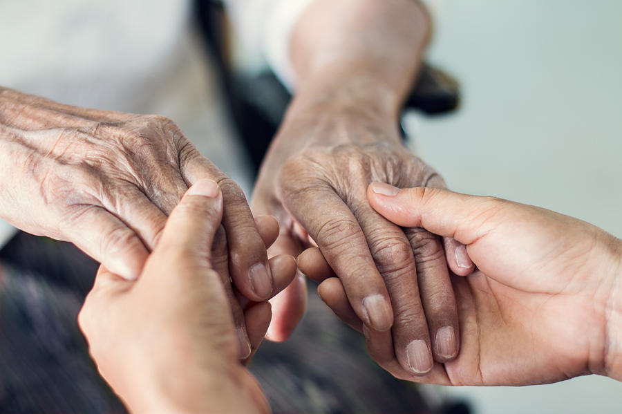 Close up hands of helping hands elderly home care. Mother and daughter. Mental health and elderly care concept Photograph by Ipopba
