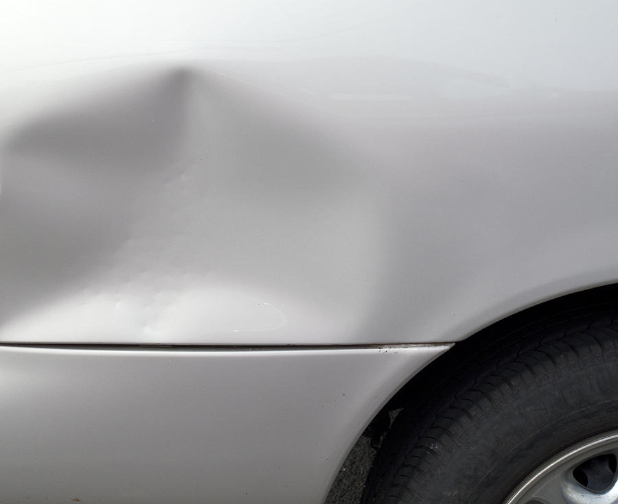 Close-up of a dent in a gray car exterior Photograph by Bruceman