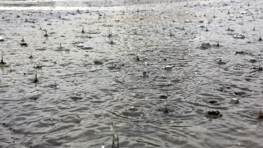 Close-up of a large puddle  of water with splashing raindrops during a downpour Photograph by Photography by Keith Getter (all rights reserved)
