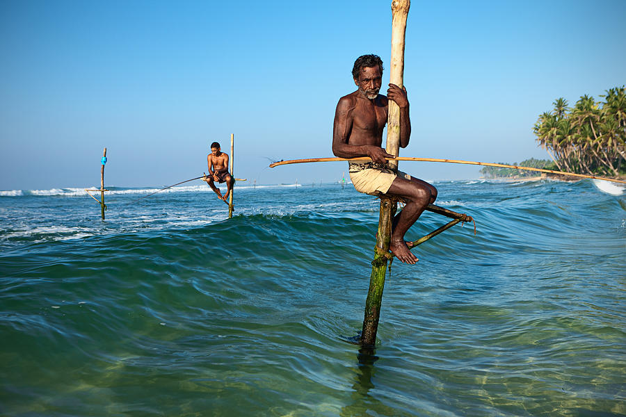 Close-up of a stilt fishermen in action, Ceylon Photograph by Hadynyah