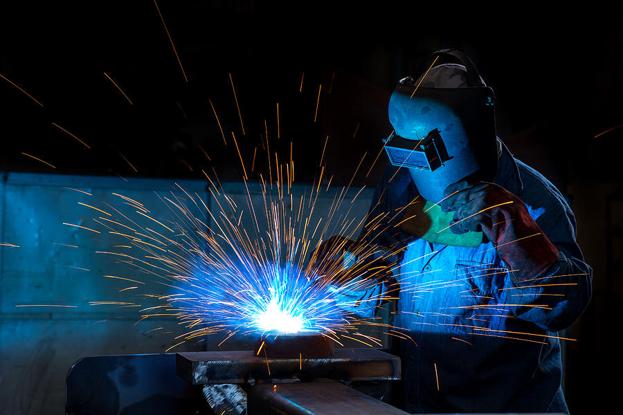Close-up of a welder wielding sparks Photograph by Uchar