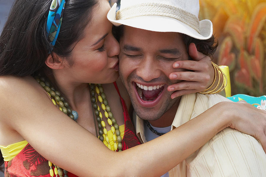 Close-up of a young woman kissing a young man Photograph by Hola Images