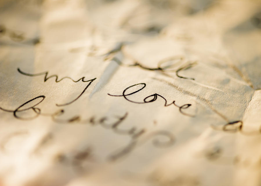 Close up of antique love letter on parchment  Photograph by Jamie Grill
