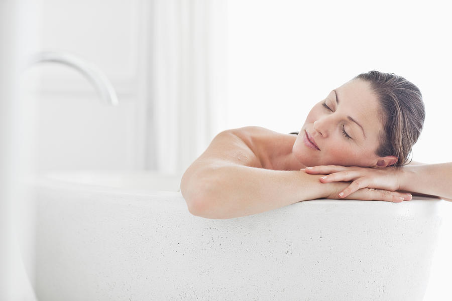 Close-up of beautiful mid adult woman relaxing in bathtub with eyes closed Photograph by OJO Images