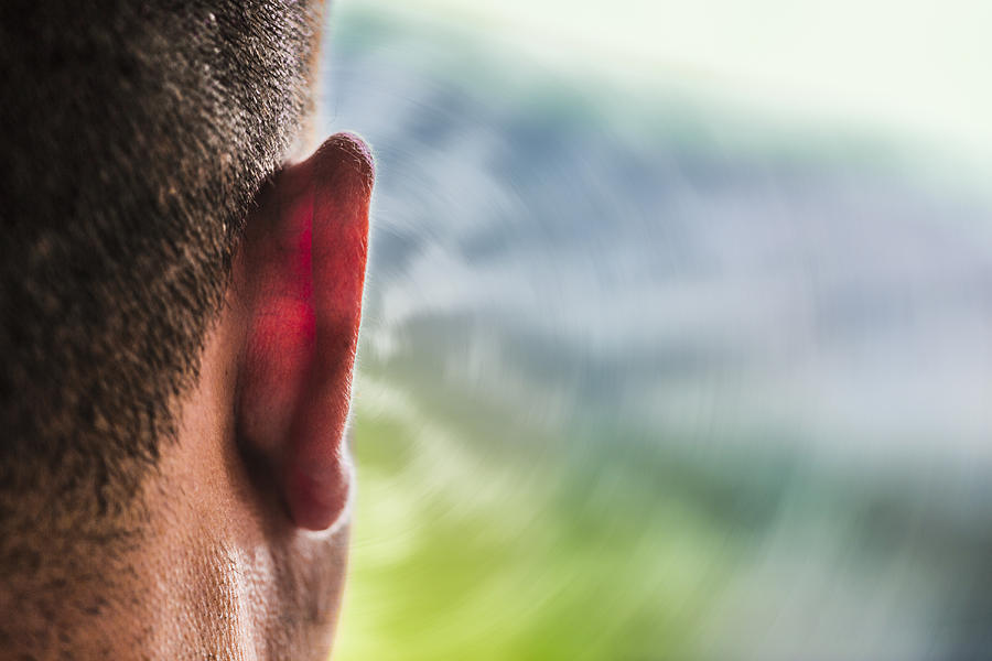 Close up of ear of Caucasian man and sound waves Photograph by Eric Raptosh Photography