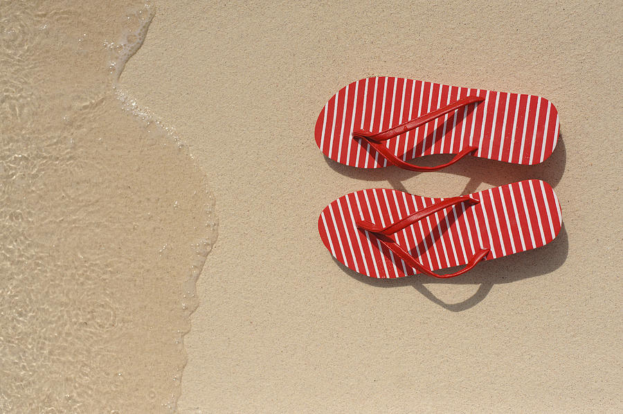 Close up of flip flops on beach Photograph by Jacobs Stock Photography Ltd