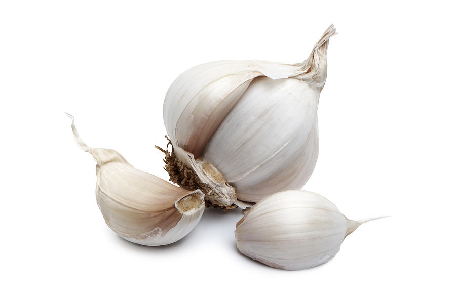 Close-up of garlic clove on white background Photograph by Macida
