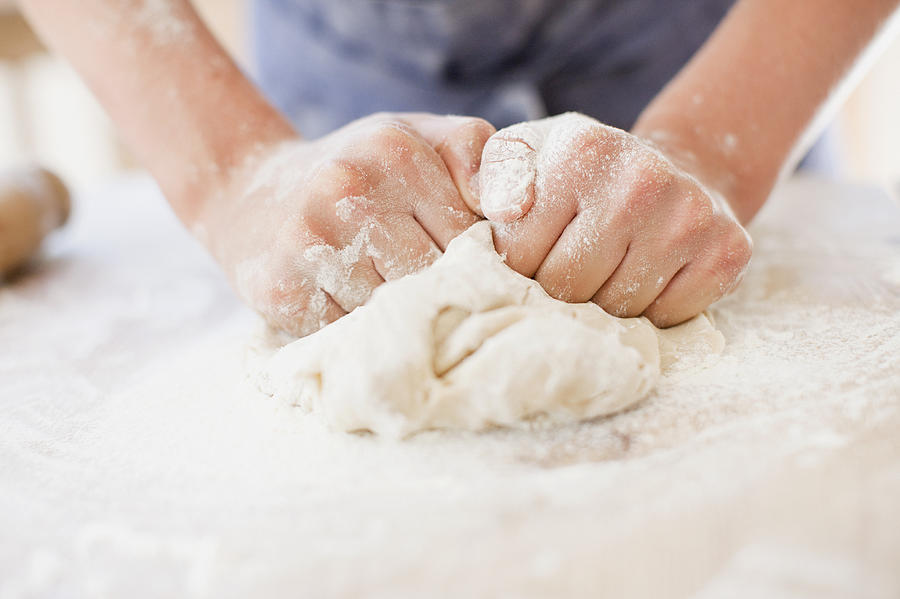 Close up of girl kneading dough Photograph by Tom Merton