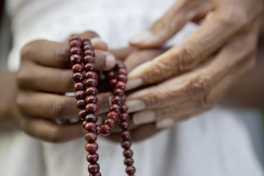 Close up of hands holding beads Photograph by Monashee Frantz