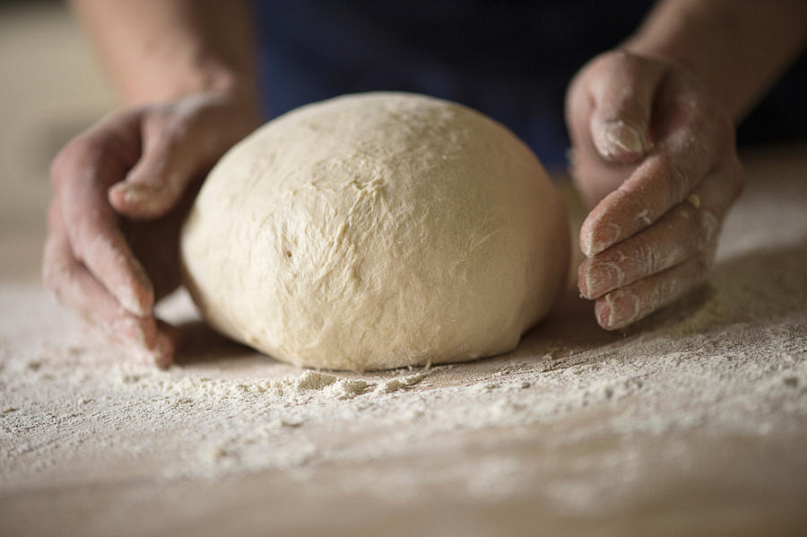 Close up of hands shaping bread dough Photograph by Ross Woodhall