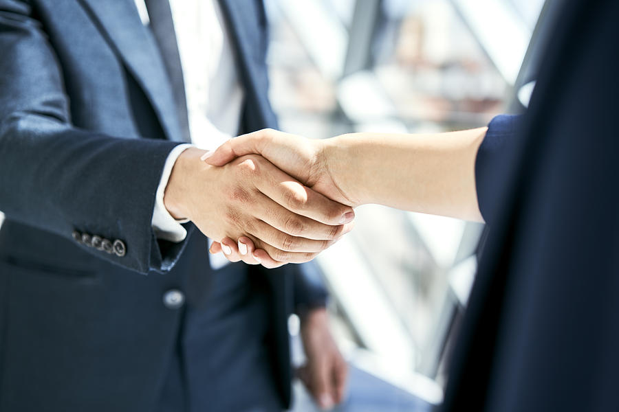 Close-up of handshake of businesswoman and businessman Photograph by Westend61