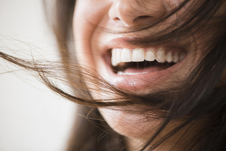 Close up of laughing woman with messy hair Photograph by JGI/Jamie Grill