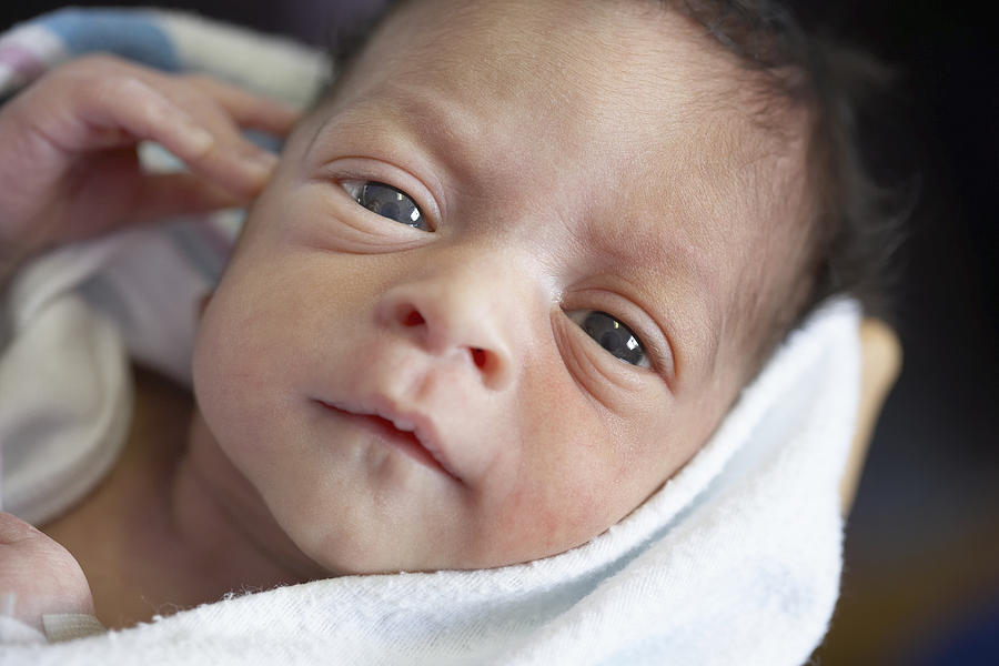 Close up of newborn African baby in blanket Photograph by ER Productions Limited