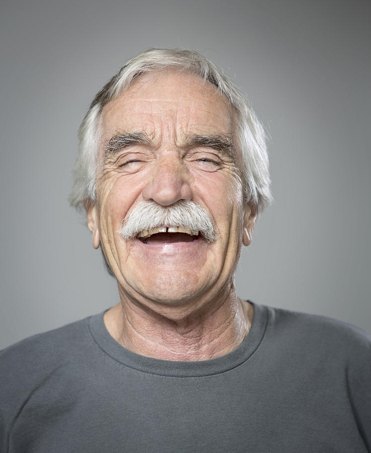 Close up of older Caucasian man laughing Photograph by Sam Diephuis