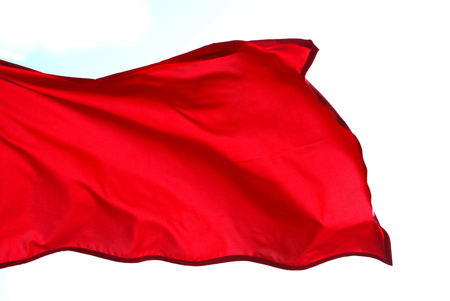 Close-up of red flag waving on white background Photograph by Kalimf