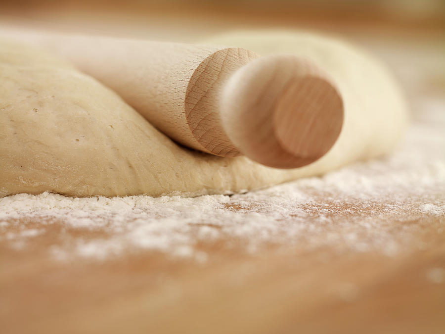 Close Up Of Rolling Pin On Dough Photograph by Adam Gault