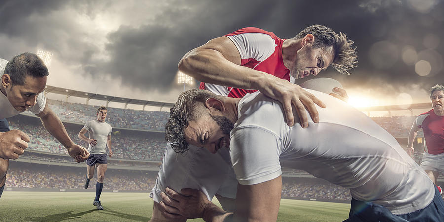 Close Up of Rugby Player Tackled Hard During Match Photograph by Peepo