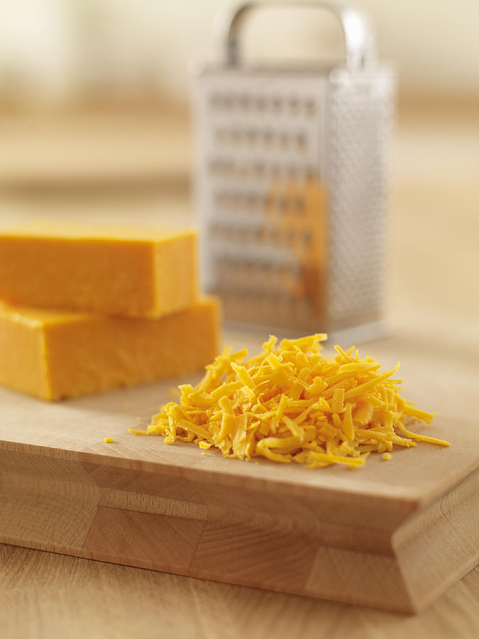 Close up of shredded cheese on cutting board Photograph by Adam Gault