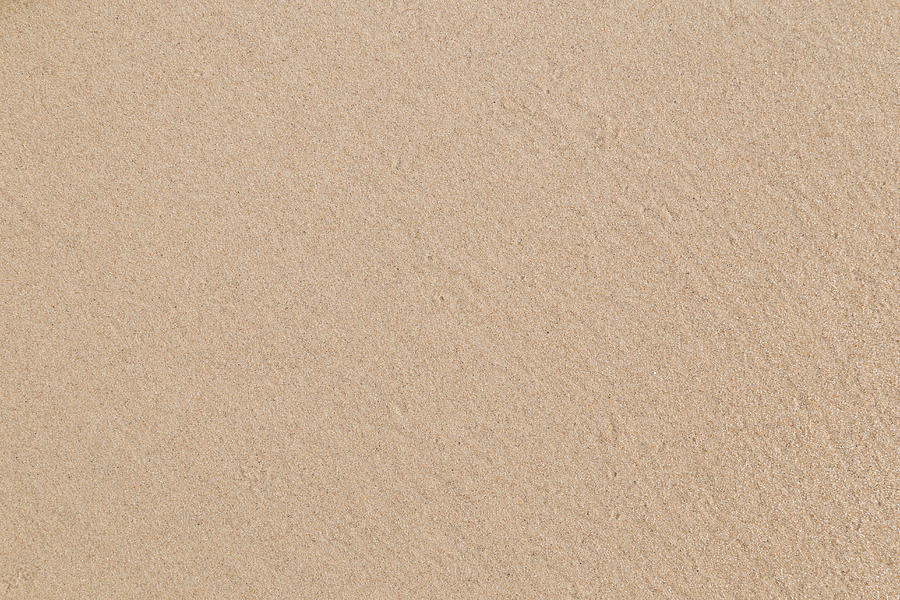 Close-up of smooth sand at a beach texture background. Photograph by Tuomas Lehtinen