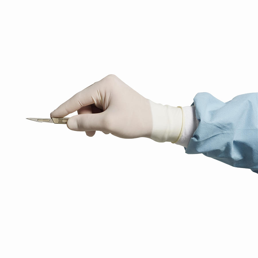Close-up of surgeons hand holding scalpel Photograph by George Doyle & Ciaran Griffin