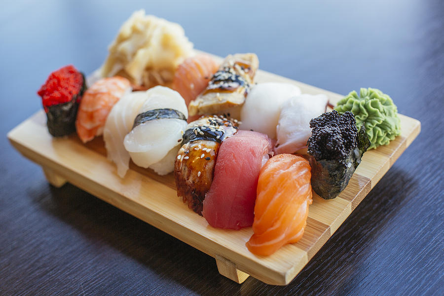 Close-up of sushi set on wooden board Photograph by Alexander Spatari