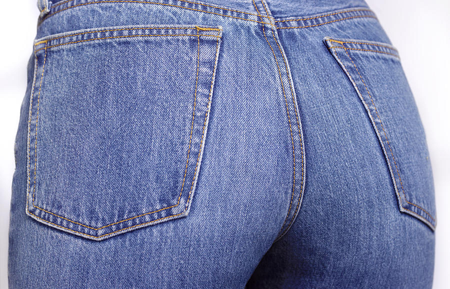 Close up of the bottom of a woman wearing denim jeans Photograph by Peter Dazeley