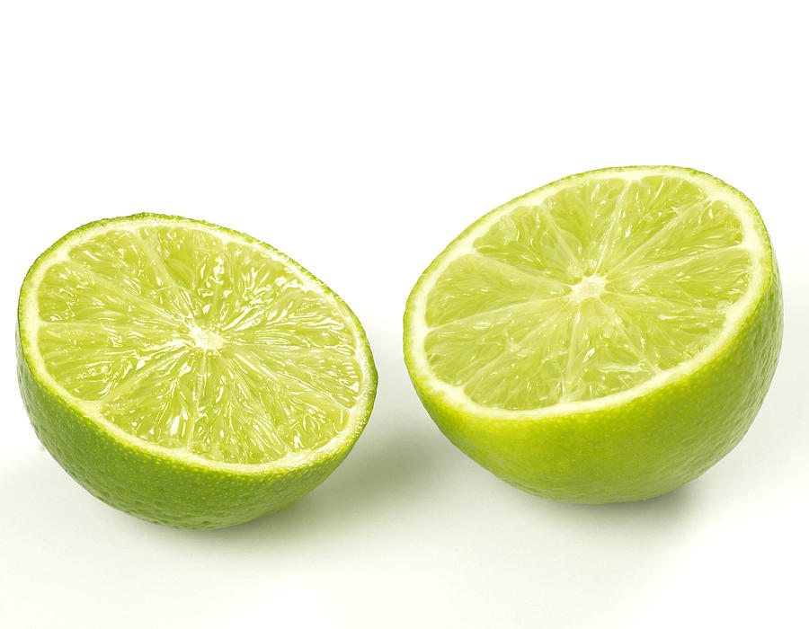 Close-up of two lime halves isolated on white Photograph by Aleaimage