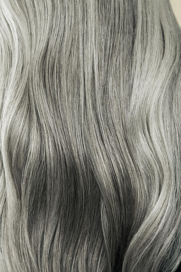 Close up of wavy, long, silver gray hair. Photograph by Andreas Kuehn