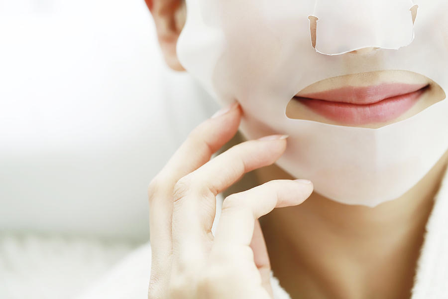 Close-Up Of Woman Applying Facial Mask Photograph by Runstudio