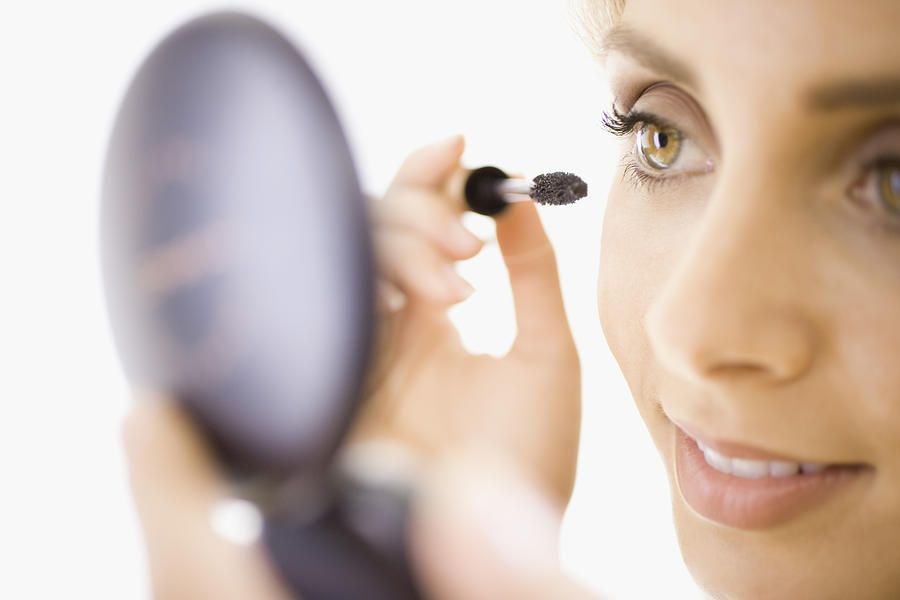 Close-up of woman applying makeup Photograph by Jupiterimages, Brand X Pictures