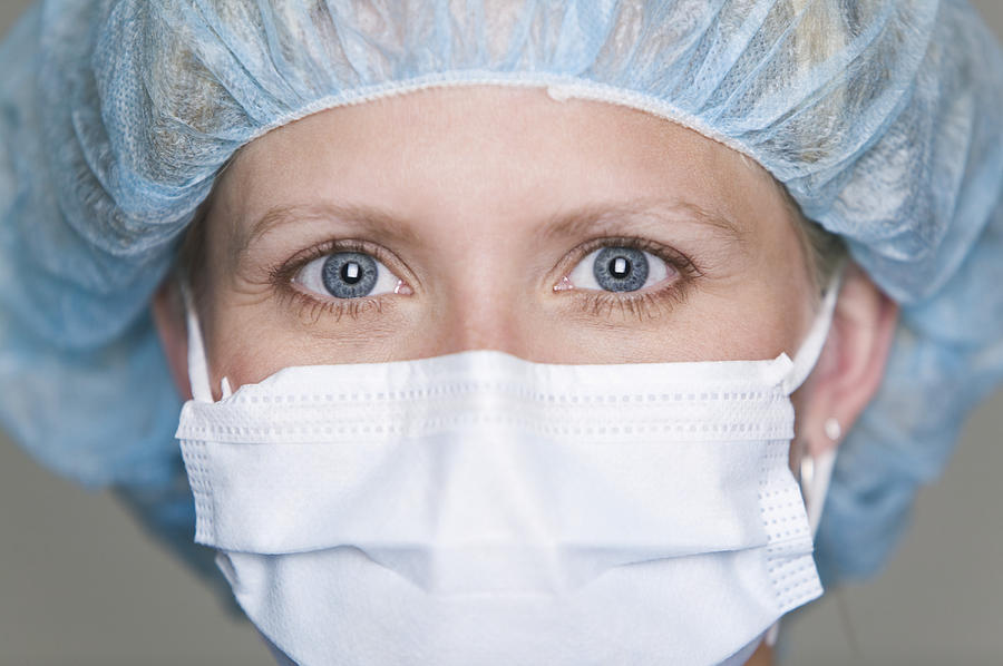 Close Up Portrait Of An Adult Female Doctor In A Surgical Mask As She Looks At The Camera Photograph by Photodisc