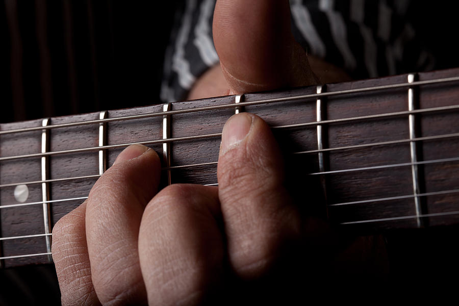 Close up shot of a mans left hand playing guitar Photograph by Kyle Lee