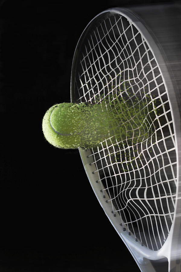 Close up tennis racket hitting ball with blurred motion Photograph by REB Images
